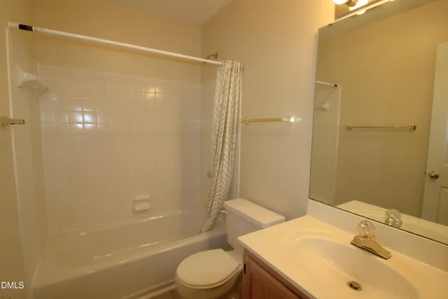 a bathroom with a sink mirror toilet and bathtub
