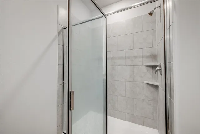 a bathroom with a glass shower door