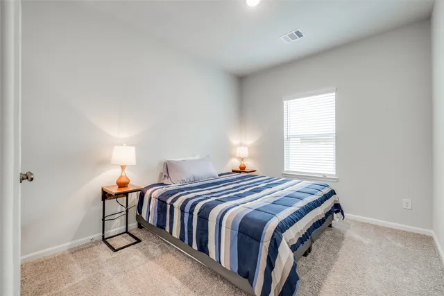 a bedroom with a bed and window