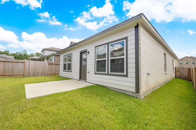 a view of a backyard with a garden and deck