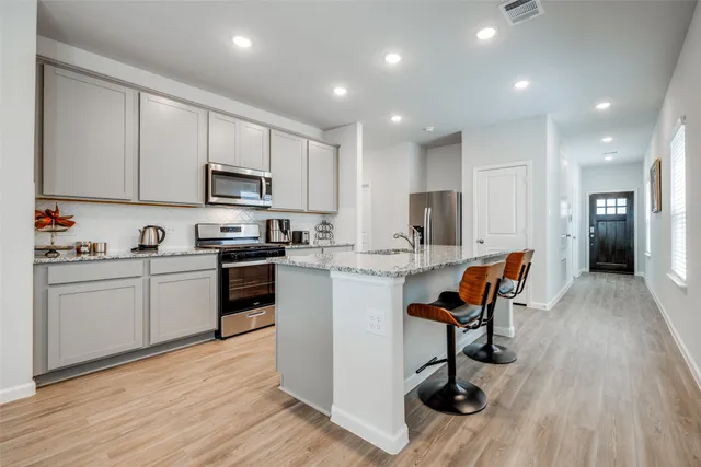 a kitchen with a sink stainless steel appliances and cabinets