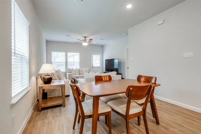 a view of a dining room with furniture and wooden floor