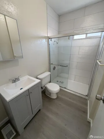 a bathroom with a sink toilet and shower