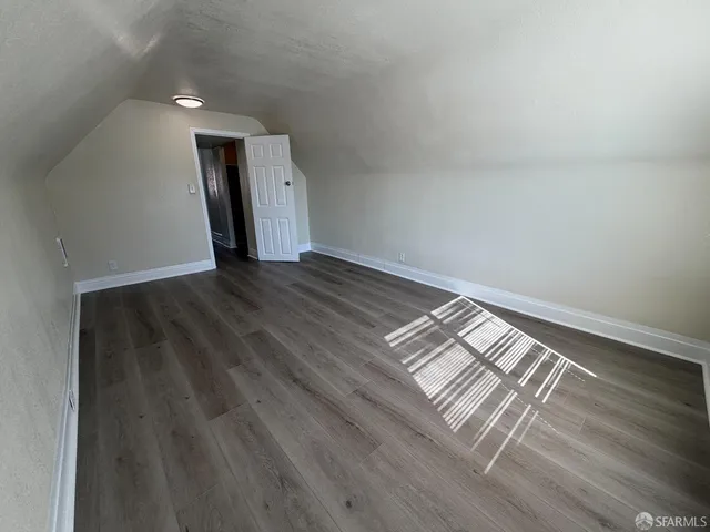 a view of wooden floor and windows in a room