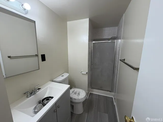 a bathroom with a toilet a sink and shower