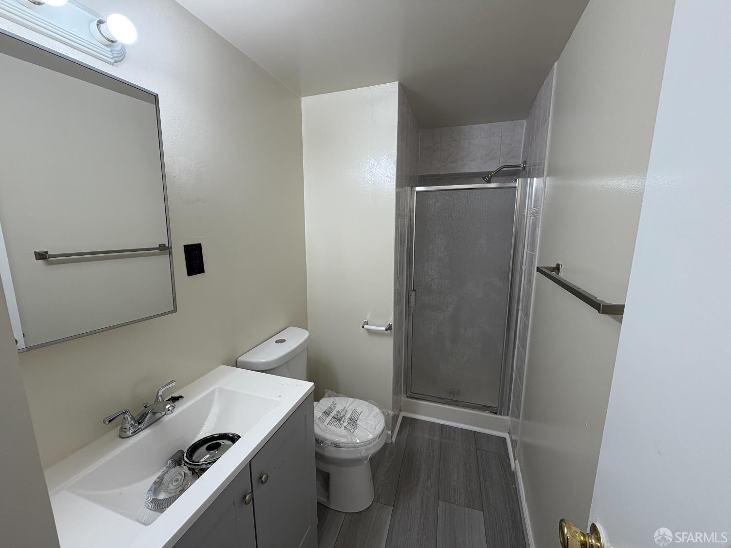 65 Minerva Street San Francisco, CA 94112 - Photo 17 of 24 a bathroom with a toilet a sink and shower