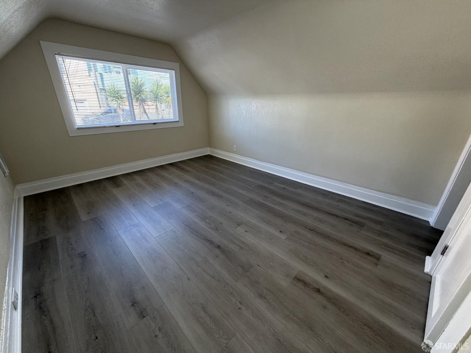 65 Minerva Street San Francisco, CA 94112 - Photo 18 of 24 an empty room with wooden floor and windows