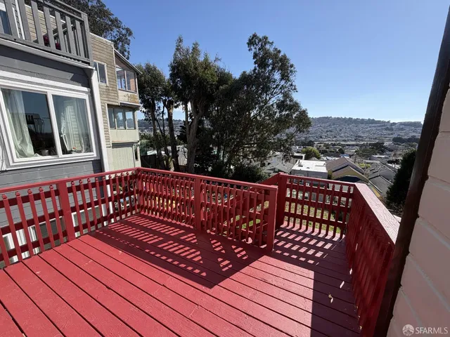 a view of a roof deck with wooden floor and fence