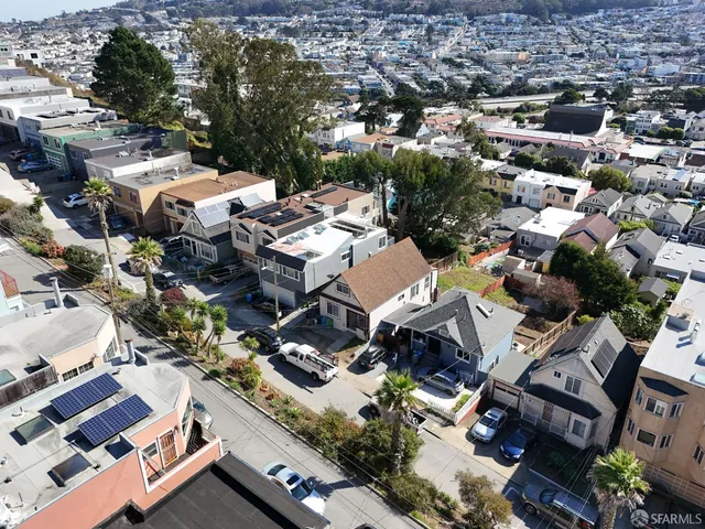 an aerial view of multiple houses with yard