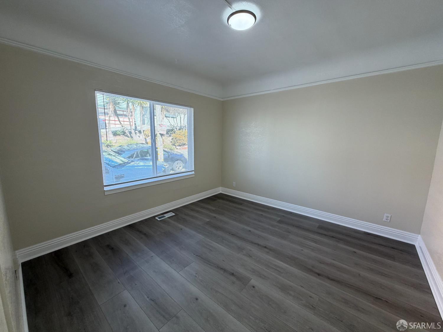 65 Minerva Street San Francisco, CA 94112 - Photo 3 of 24 a view of an empty room with wooden floor and a window