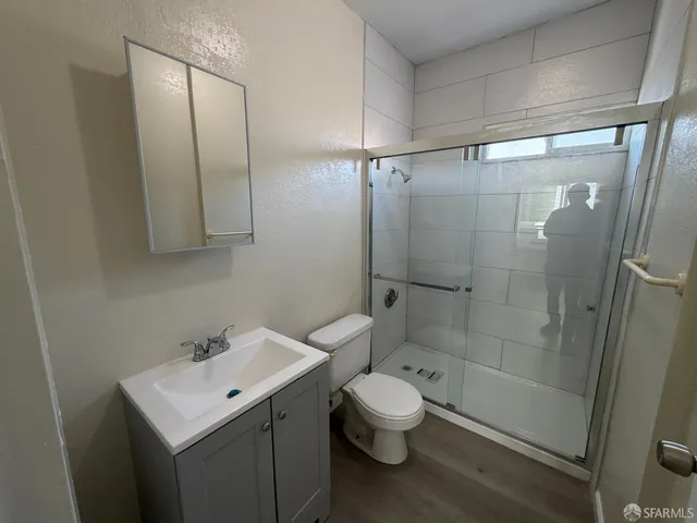 a bathroom with a sink toilet and shower