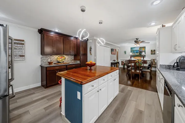 a kitchen with stainless steel appliances granite countertop a stove and a refrigerator
