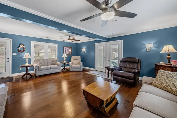 a living room with furniture and a wooden floor
