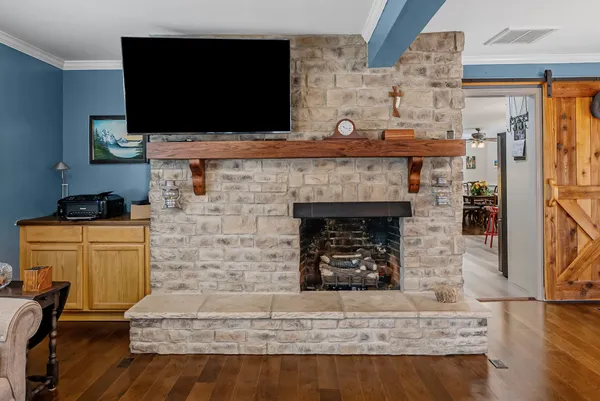 a living room with fireplace and a flat screen tv