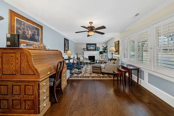 a living room with furniture a wooden floor and a chandelier