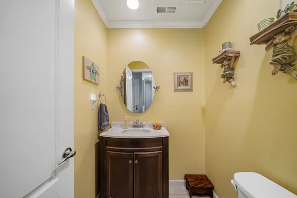 a bathroom with a sink vanity mirror and toilet