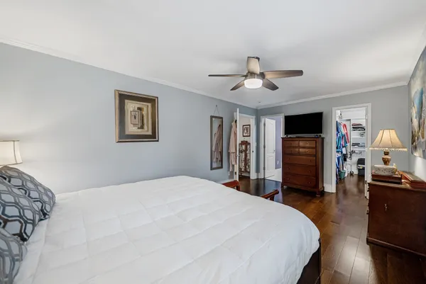 a spacious bedroom with a bed and a chandelier