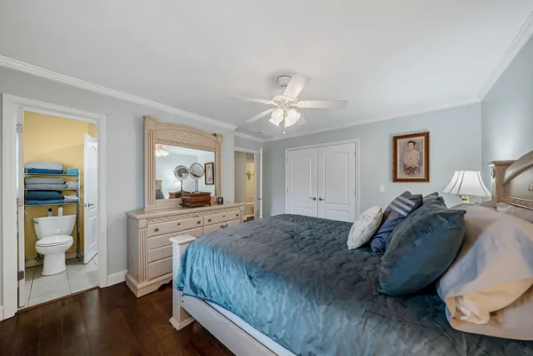 a spacious bedroom with a bed and a chandelier