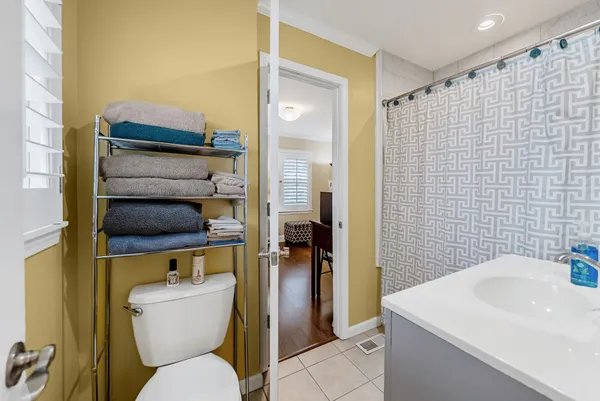 a bathroom with a toilet a sink and shower
