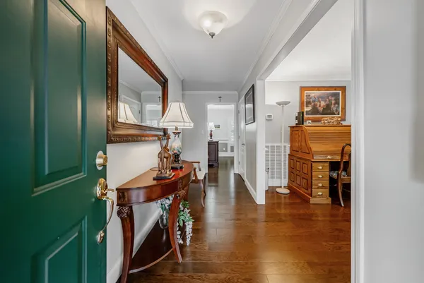 a view of an entryway with wooden floor