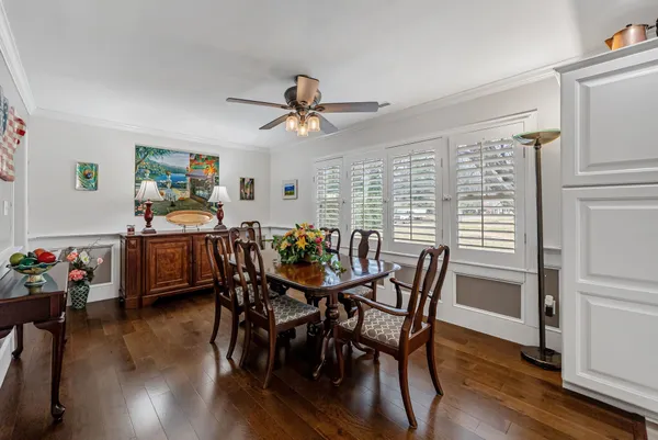 a view of a dining room with furniture and wooden floor