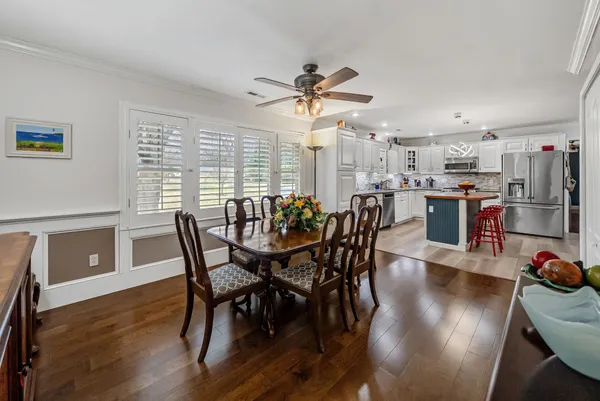 a view of a dining room with furniture window and wooden floor