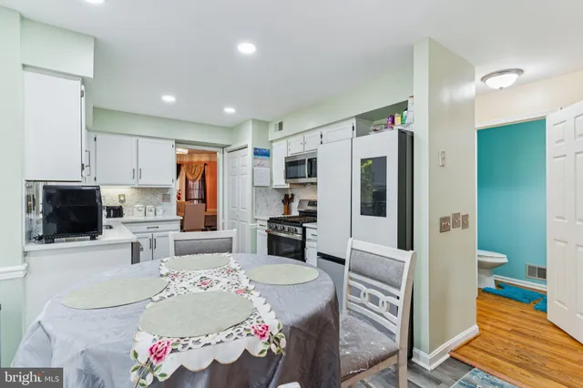 a kitchen with stainless steel appliances kitchen island granite countertop a refrigerator and a stove top oven