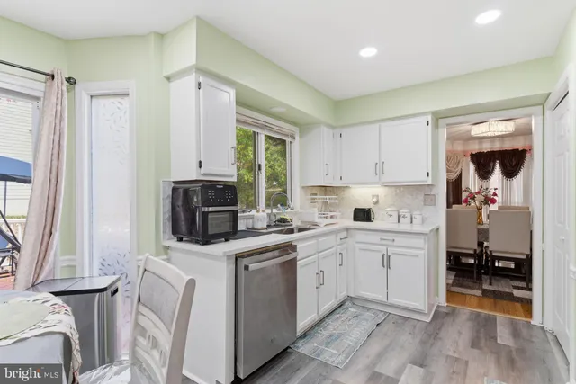 a kitchen with a sink appliances and cabinets