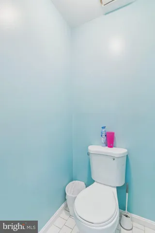 a white toilet sitting next to a bathroom sink