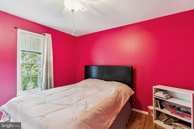 a large bed sitting in a bedroom next to a window