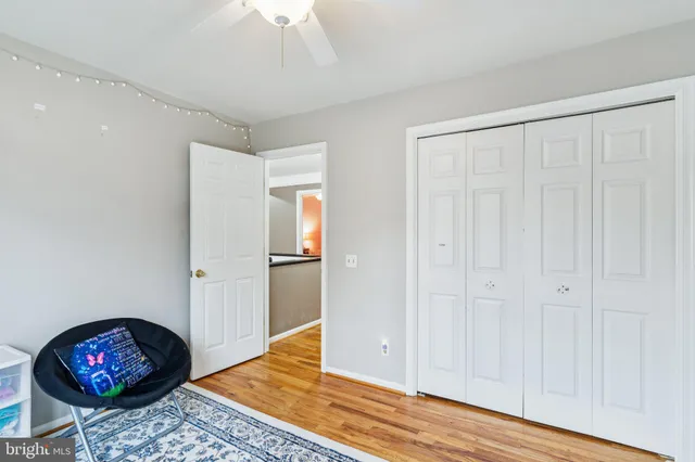 a view of a livingroom with wooden floor and a rug