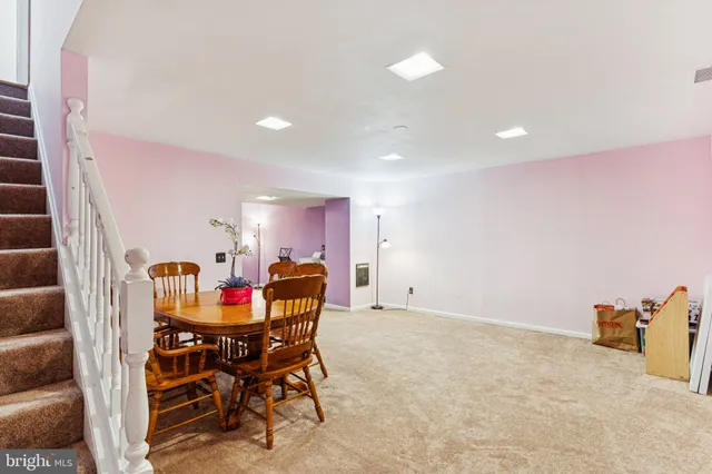a dining room with furniture and kitchen view