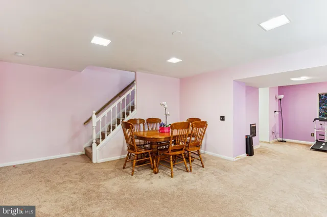 a dining room with furniture and wooden floor