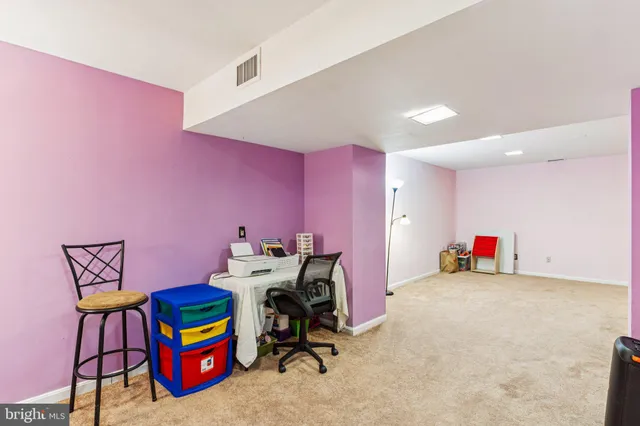 a view of a workspace with furniture and toys