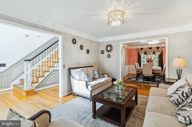 a living room with furniture a rug and a window