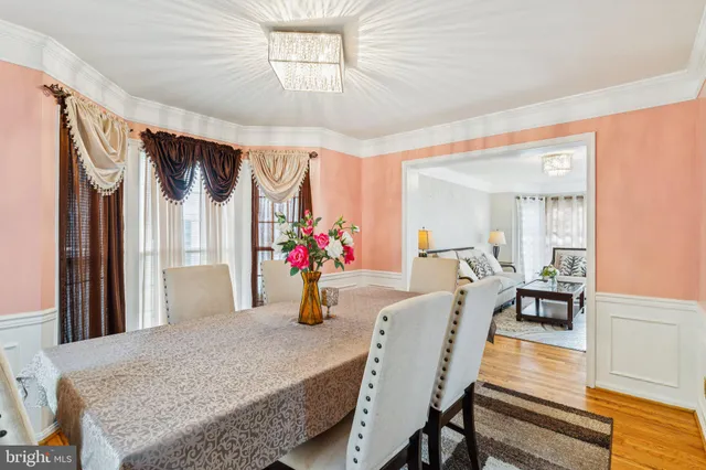a view of a dining room with furniture and a chandelier