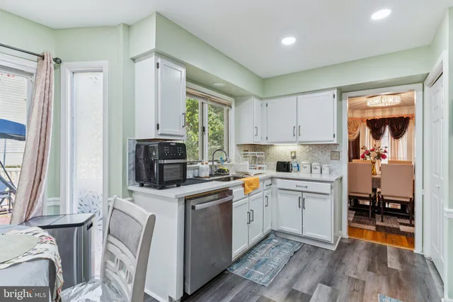 a kitchen with a sink appliances and cabinets