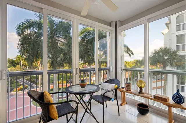 a view of a city from a dining room with furniture and floor to ceiling windows