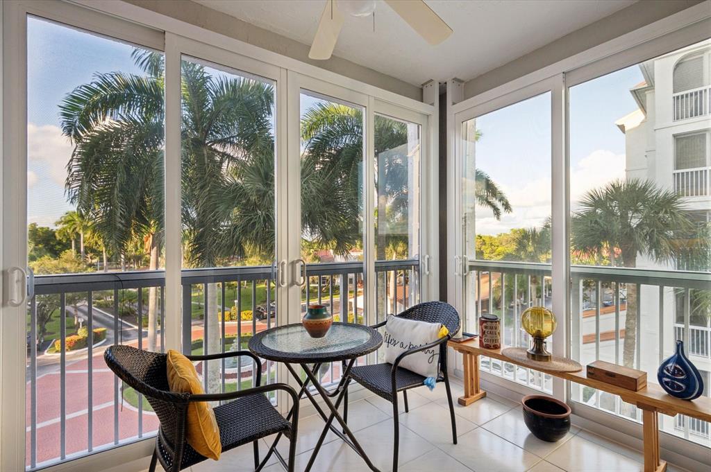 4112 West Palm Aire Drive, Unit 124A Pompano Beach, FL 33069 - Photo 14 of 19 a view of a city from a dining room with furniture and floor to ceiling windows
