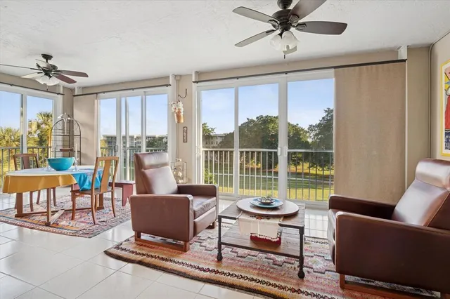 a living room with furniture and a floor to ceiling window