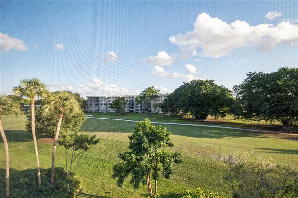 4112 West Palm Aire Drive, Unit 124A Pompano Beach, FL 33069 - Photo 19 of 19 a view of a water pond with an ocean view