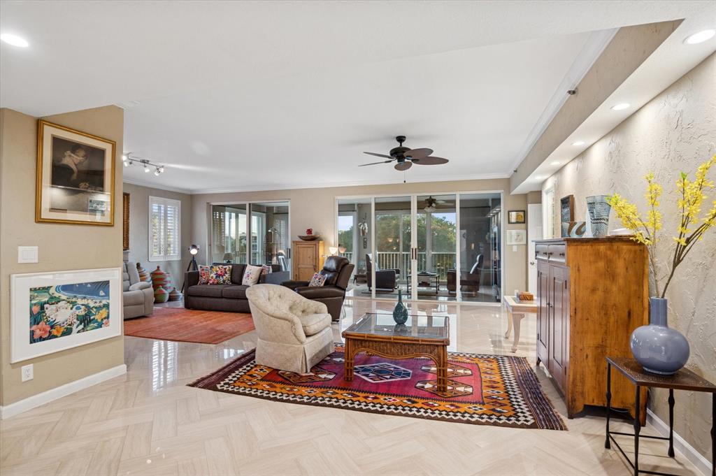 4112 West Palm Aire Drive, Unit 124A Pompano Beach, FL 33069 - Photo 2 of 19 a living room with furniture and a floor to ceiling window
