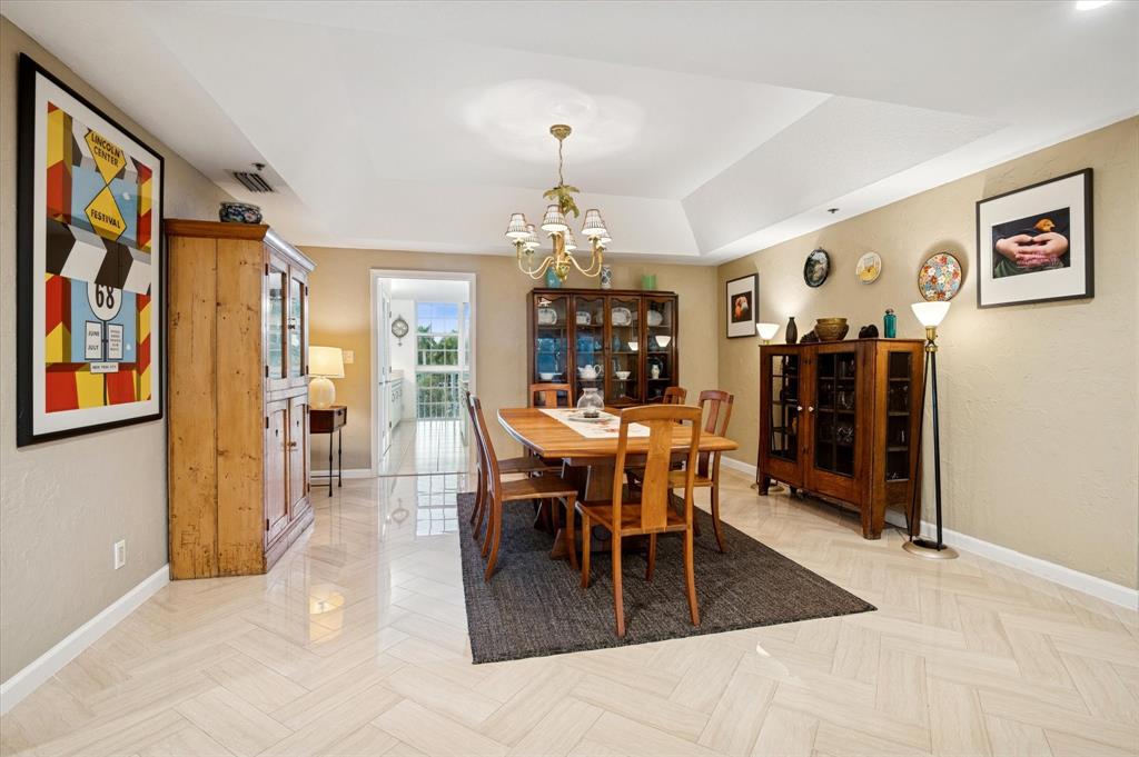 4112 West Palm Aire Drive, Unit 124A Pompano Beach, FL 33069 - Photo 6 of 19 a view of a dining room with furniture and chandelier