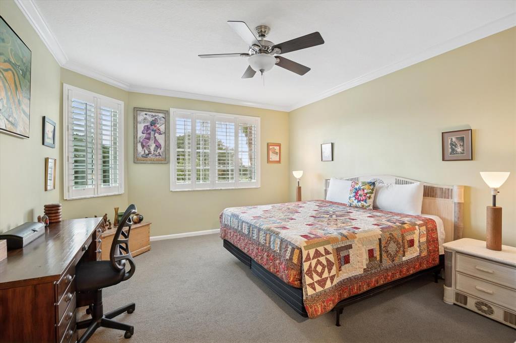 4112 West Palm Aire Drive, Unit 124A Pompano Beach, FL 33069 - Photo 9 of 19 a bedroom with a bed a desk and chair next to a window