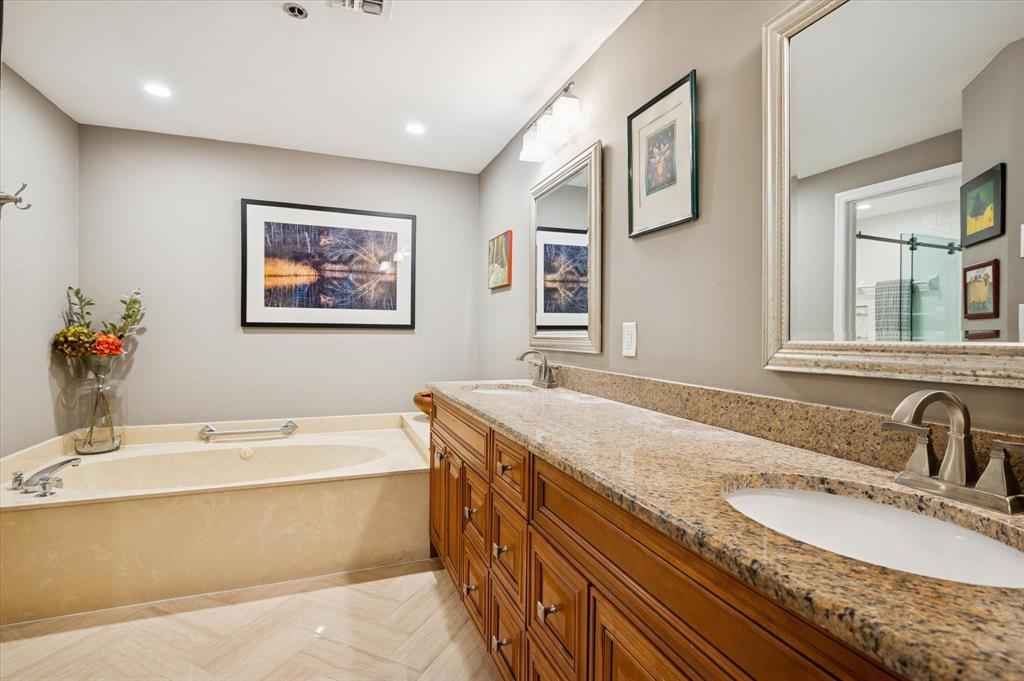4112 West Palm Aire Drive, Unit 124A Pompano Beach, FL 33069 - Photo 10 of 19 a bathroom with a granite countertop tub sink and mirror