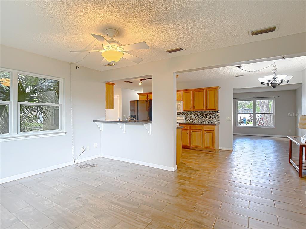 7318 Tranquil Drive Spring Hill, FL 34606 - Photo 17 of 38 a view of an entryway with wooden floor and a kitchen