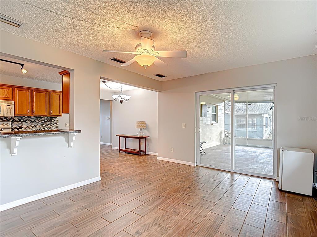 7318 Tranquil Drive Spring Hill, FL 34606 - Photo 18 of 38 a view of an empty room with window and wooden floor