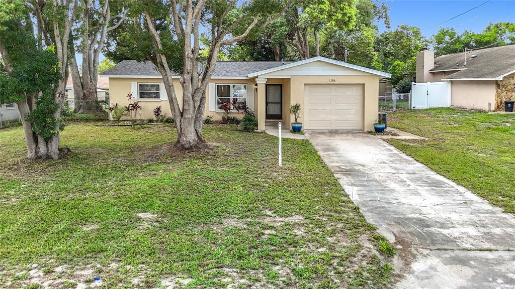7318 Tranquil Drive Spring Hill, FL 34606 - Photo 2 of 38 a front view of a house with a yard