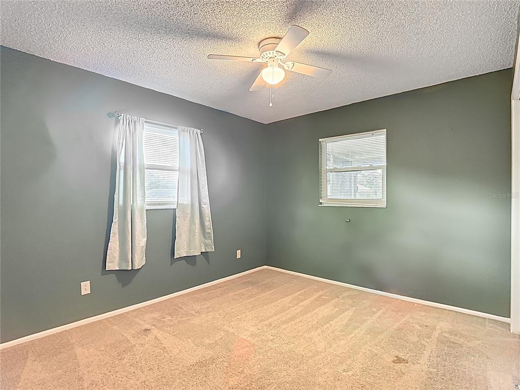 7318 Tranquil Drive Spring Hill, FL 34606 - Photo 21 of 38 an empty room with windows and closet