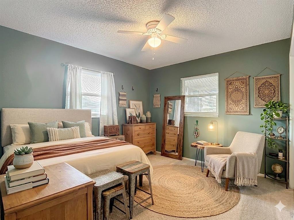 7318 Tranquil Drive Spring Hill, FL 34606 - Photo 23 of 38 a bedroom with a bed and wooden floor